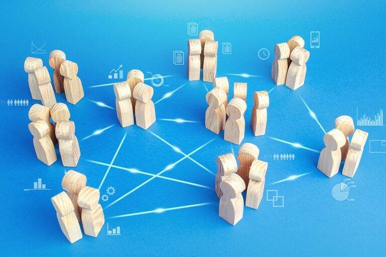 A group of wooden pegs shaped like people with interconnecting lines