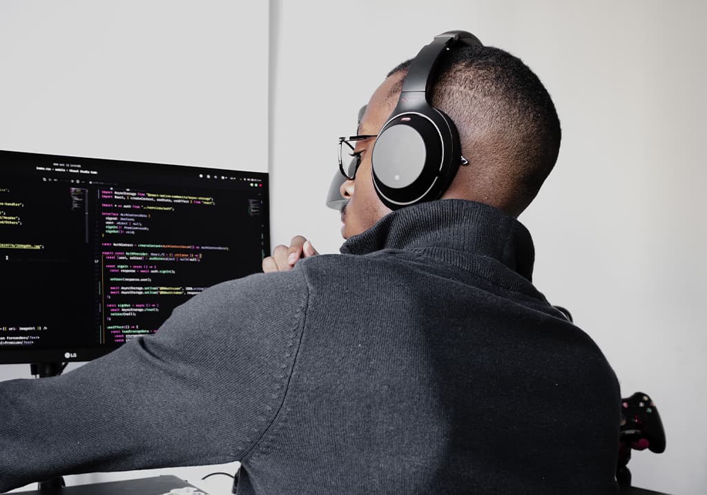 A developer is coding at his computer