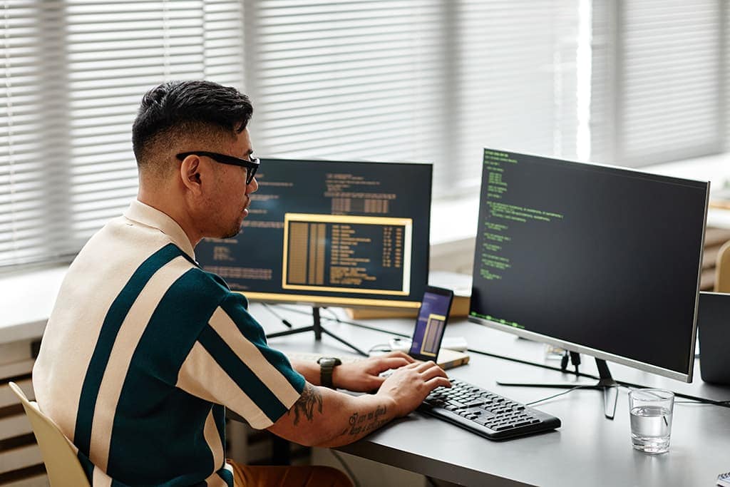 A developer is coding at his computer